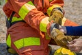 Firefighters buddy help to wearing fire protection gloves