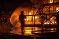 Firefighters carrying a ladder during a firefighting exercise