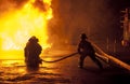 Firefighters controlling water hose