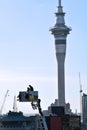 Firefighters on a Crane Platform against Auckland Sky Tower