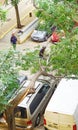 Firefighters cutting a fallen tree against the facade of a building in Barcelona