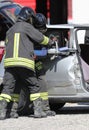 firefighters cutting the sheets of the crashed car with a powerf