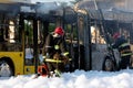 Firefighters extinguish burning coach with foam