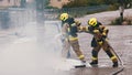 Firefighters extinguish fire from the burning car using foam Royalty Free Stock Photo