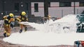 Firefighters extinguish fire from the burning car using foam Royalty Free Stock Photo