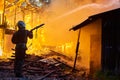 Firefighters extinguish a fire in a farm building Royalty Free Stock Photo