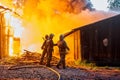 Firefighters extinguish a fire in a farm building Royalty Free Stock Photo