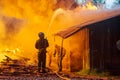 Firefighters extinguish a fire in a farm building Royalty Free Stock Photo