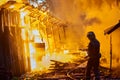 Firefighters extinguish a fire in a farm building Royalty Free Stock Photo