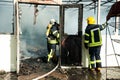 Firefighters extinguish a large fire at Troyeschina market with water and fire extinguishers