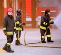 Firefighters during the extinguishing of a fire and old toned ef Royalty Free Stock Photo