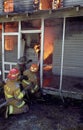 Firefighters fight fire and flames at a house fire