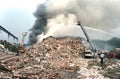 Firefighters fight a mountain of trash fire