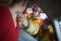 Firefighters helping an injured woman in a car