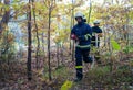 Firefighters men at action, running through smoke with shovels to stop fire in forest. Royalty Free Stock Photo