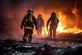 Firefighters next to a fire truck extinguishing a fire Royalty Free Stock Photo