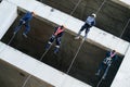 Firefighters practice rappelling on tower.