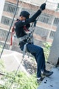 Firefighters practice rappelling on tower.