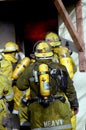 Several firefighters prepares to enter a house on fire