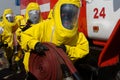 Firefighters in protective suits, gas masks and a hose are getting ready for work Royalty Free Stock Photo