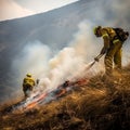 Firefighters in protective suits and masks extinguish a fire in nature in the mountains, hot summer,