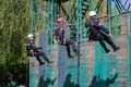 Firefighters are rappelling and climbing ropes