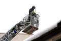 Firefighters remove snow from the eaves