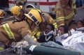 Firefighters and rescuers remove injured
