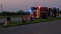 Firefighters responding to fire on road. Firefighters near a firetruck with flashing lights during a road side fire in San Antonio