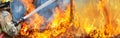 Firefighters spray water to wildfire Royalty Free Stock Photo