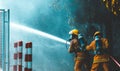 firefighters spray water to wildfire Royalty Free Stock Photo