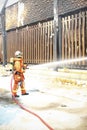 Firefighters spray water to wildfire Royalty Free Stock Photo