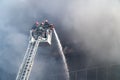 Firefighters on stairs extinguish a big fire Royalty Free Stock Photo