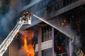 Firefighters on stairs extinguish a big fire