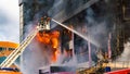 Firefighters on stairs extinguish a big fire Royalty Free Stock Photo