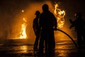 Firefighters standing in a line fighting a fire Royalty Free Stock Photo