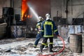 Firefighters struggle to extinguish the fire that broke out at a Royalty Free Stock Photo