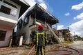 Firefighters of the Surinamese fire brigade extinguish a burning house in the center of Paramaribo, Suriname, South America