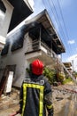 Firefighters of the Surinamese fire brigade extinguish a burning house in the center of Paramaribo, Suriname, South America