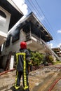 Firefighters of the Surinamese fire brigade extinguish a burning house in the center of Paramaribo, Suriname, South America