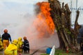 Firefighters train near the stump.