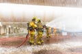 Firefighters training, foreground is drop of water springer