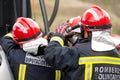 Firefighters using hydraulic tools during a rescue operation training. Rescuers unlock the passenger in car after