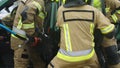 Firefighters using jaws of life to extricate trapped victim from the car