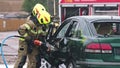 Firefighters using jaws of life to extricate trapped victim from the car