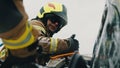 Firefighters using jaws of life to extricate trapped victim from the car Royalty Free Stock Photo