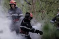 Firefighters using water hoses to extinguish a fire