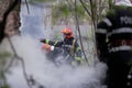 Firefighters using water hoses to extinguish a fire