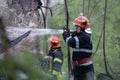 Firefighters using water hoses to extinguish a fire