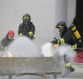 Firefighters who use a foamer to extinguish a fire during an exe Royalty Free Stock Photo